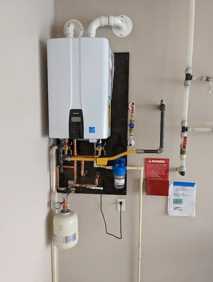 Professional plumber installing copper piping in a Montville home